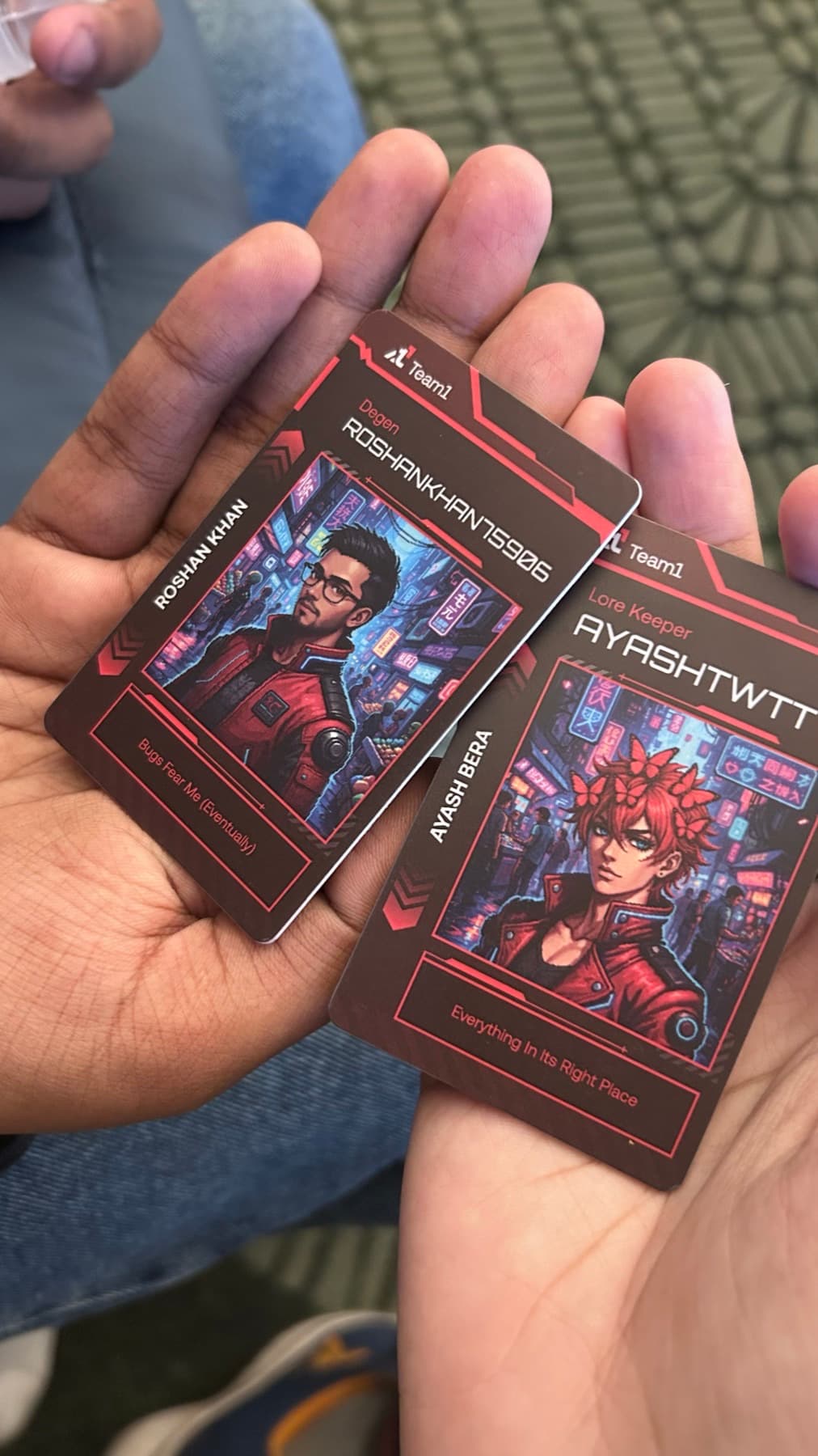 Two Team1 builder cards held in hand